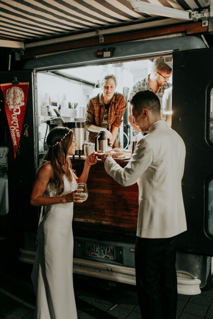 Bride and Groom eating donuts from a food cart